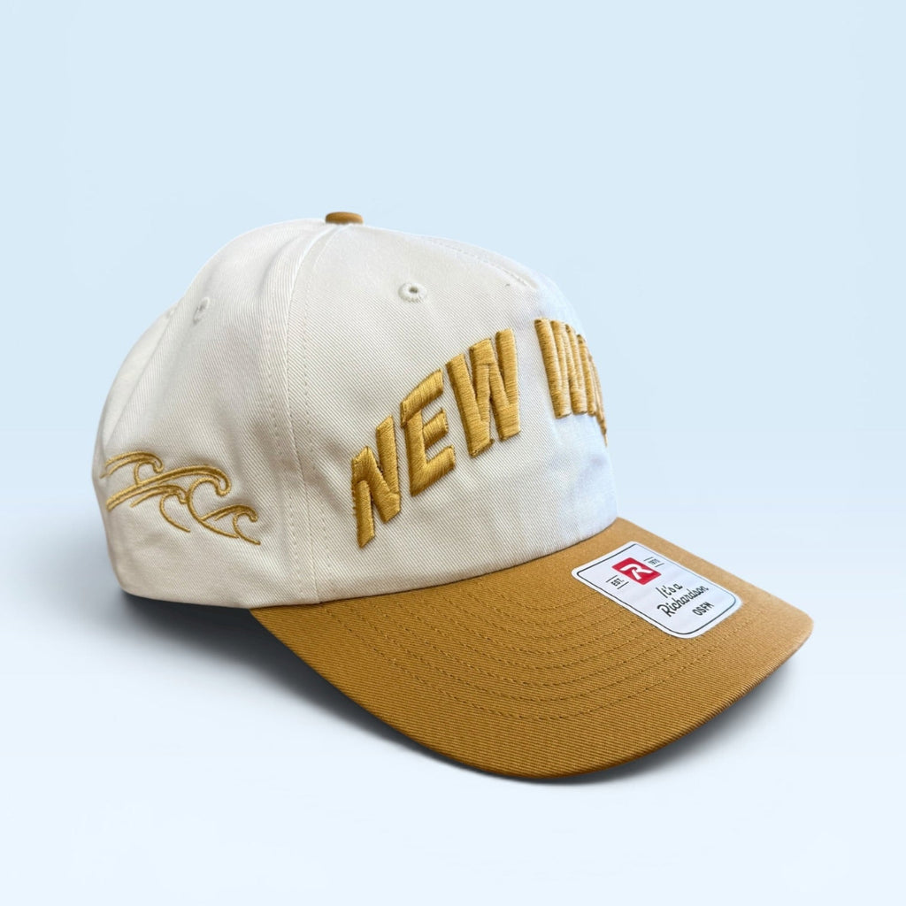 Beige and brown cap with 'NEW' text on a light blue background