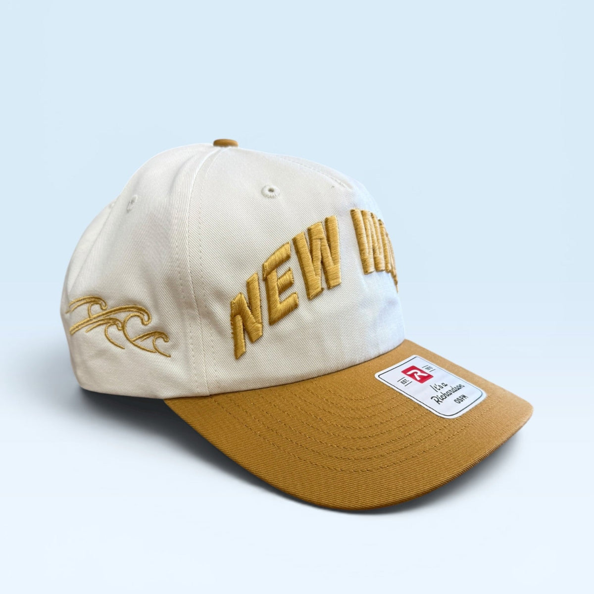 Beige and brown cap with 'NEW' text on a light blue background