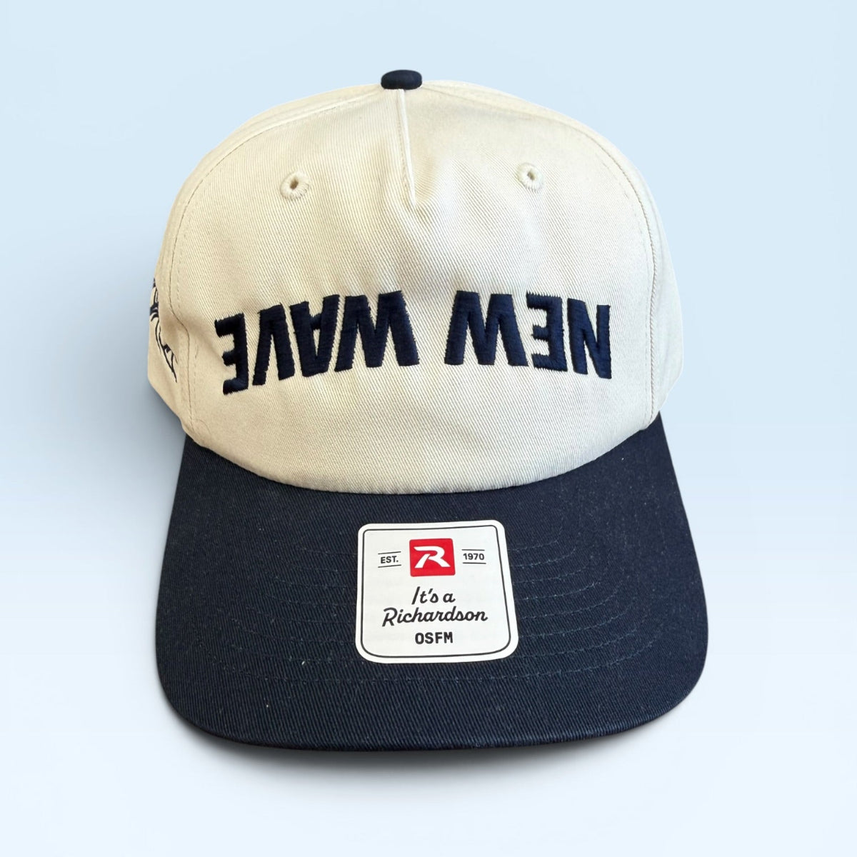 Two-tone cap with 'New Wave' text on a light blue background