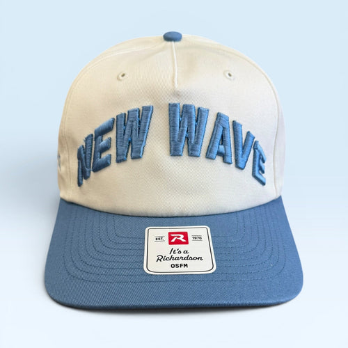 Beige and blue cap with 'NEW WAVE' text on a light blue background