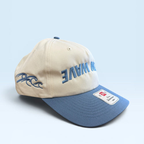 Beige and blue cap with branding on a light blue background