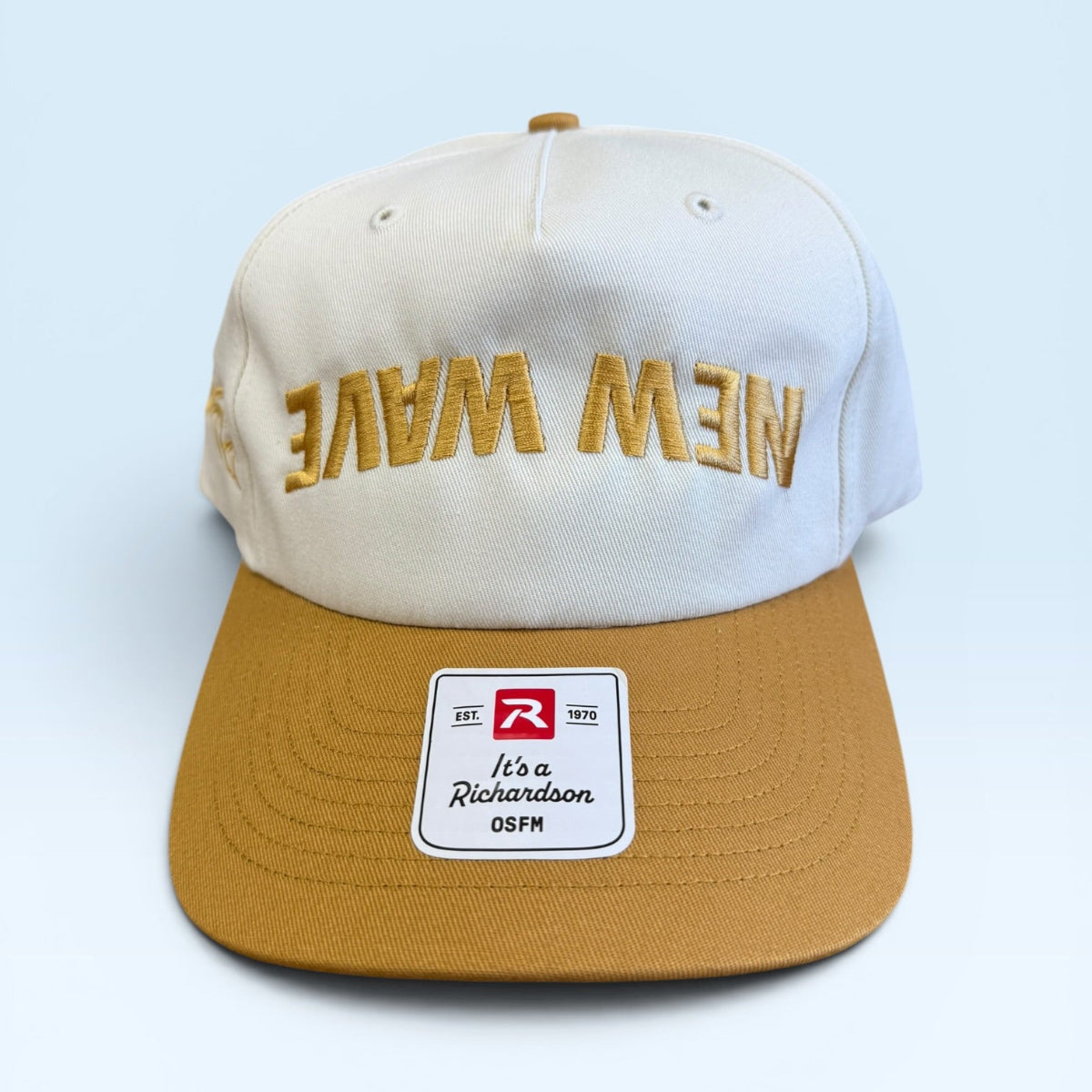 White and brown cap with 'New Wave' text and a logo on a light blue background