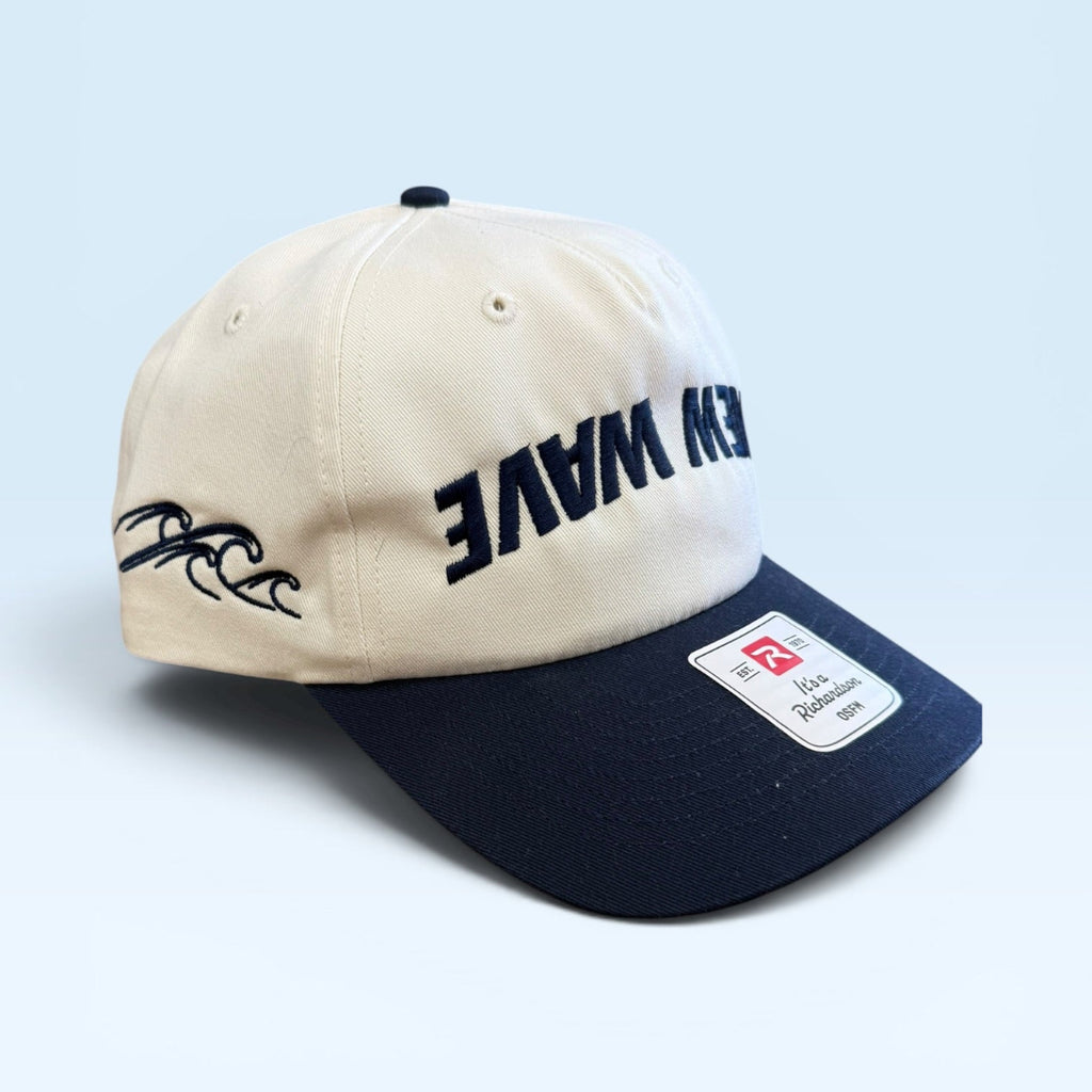 Beige and navy cap with text and logo on a light blue background