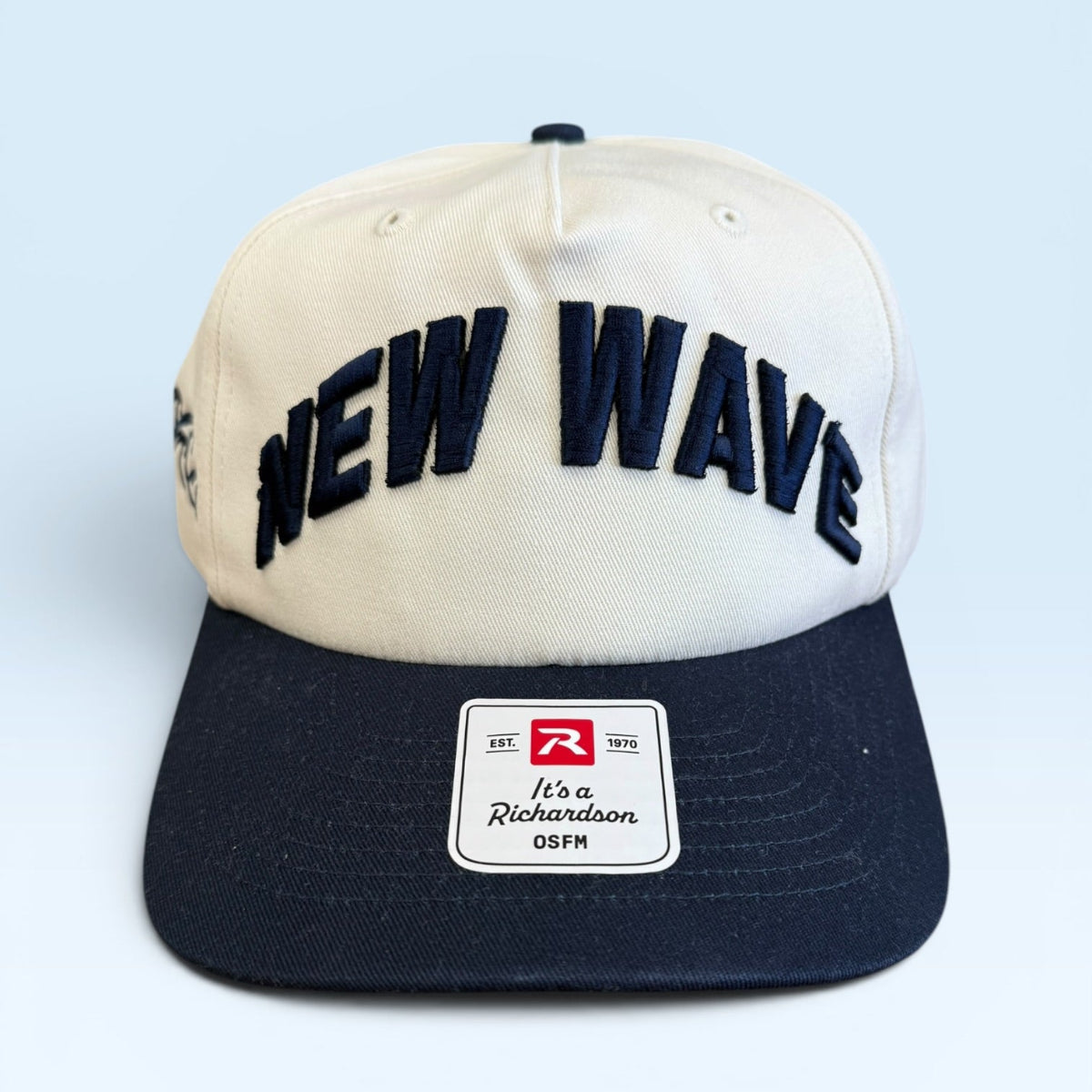 Cap with 'NEW WAVE' text on a light blue background