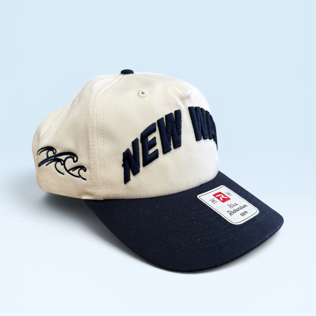 Beige and navy cap with 'NEW' text on a light blue background